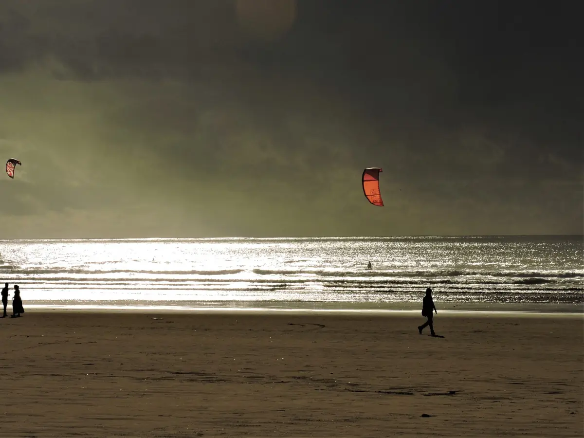 Kitesurfers and walkers on the beach at Essaouira